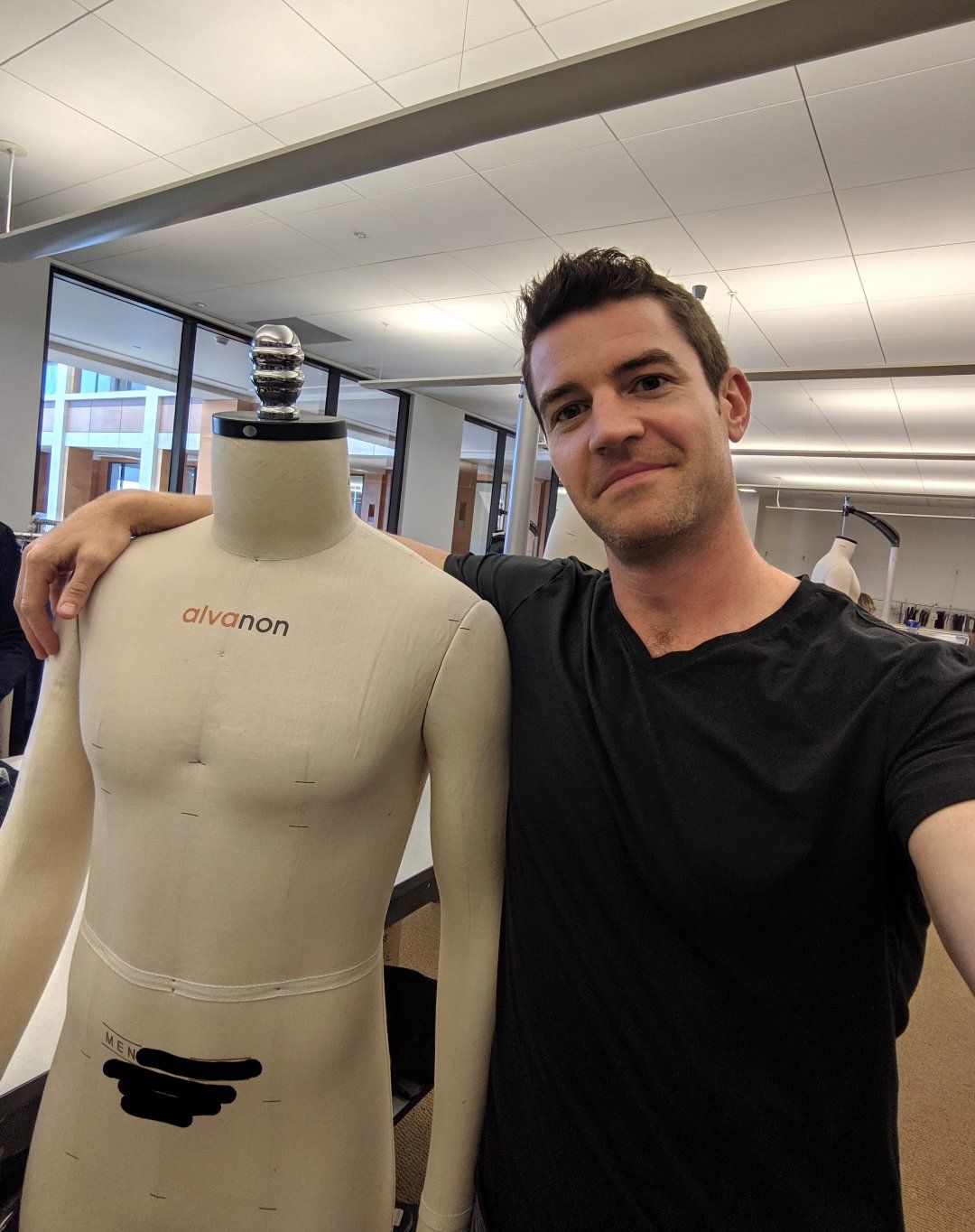 Fit model Joe Cummings standing beside the Alvanon dress form made to his exact measurements, used for fittings when he is not there