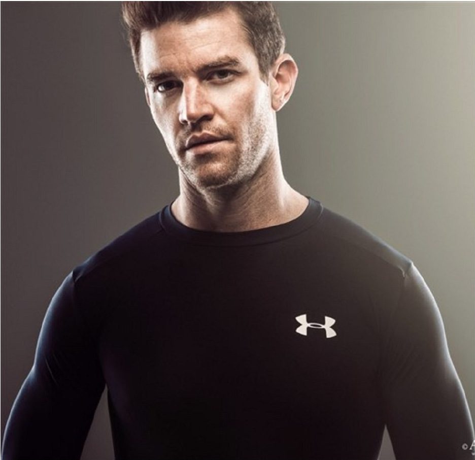 Joe Cummings in fitted black performance apparel for men's fit modeling