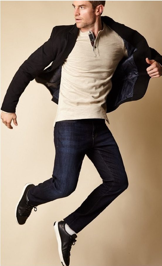 Joe Cummings demonstrating garment movement in a jacket and dark denim